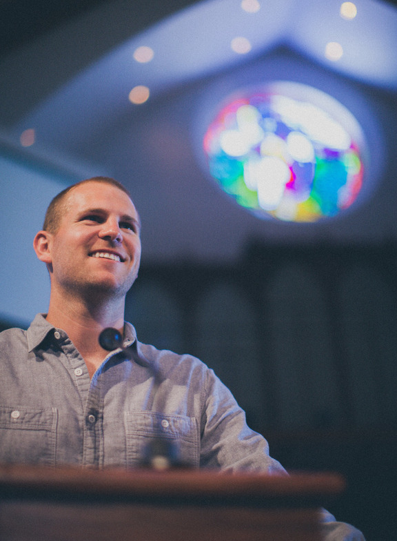 Church speaker welcoming people to worship